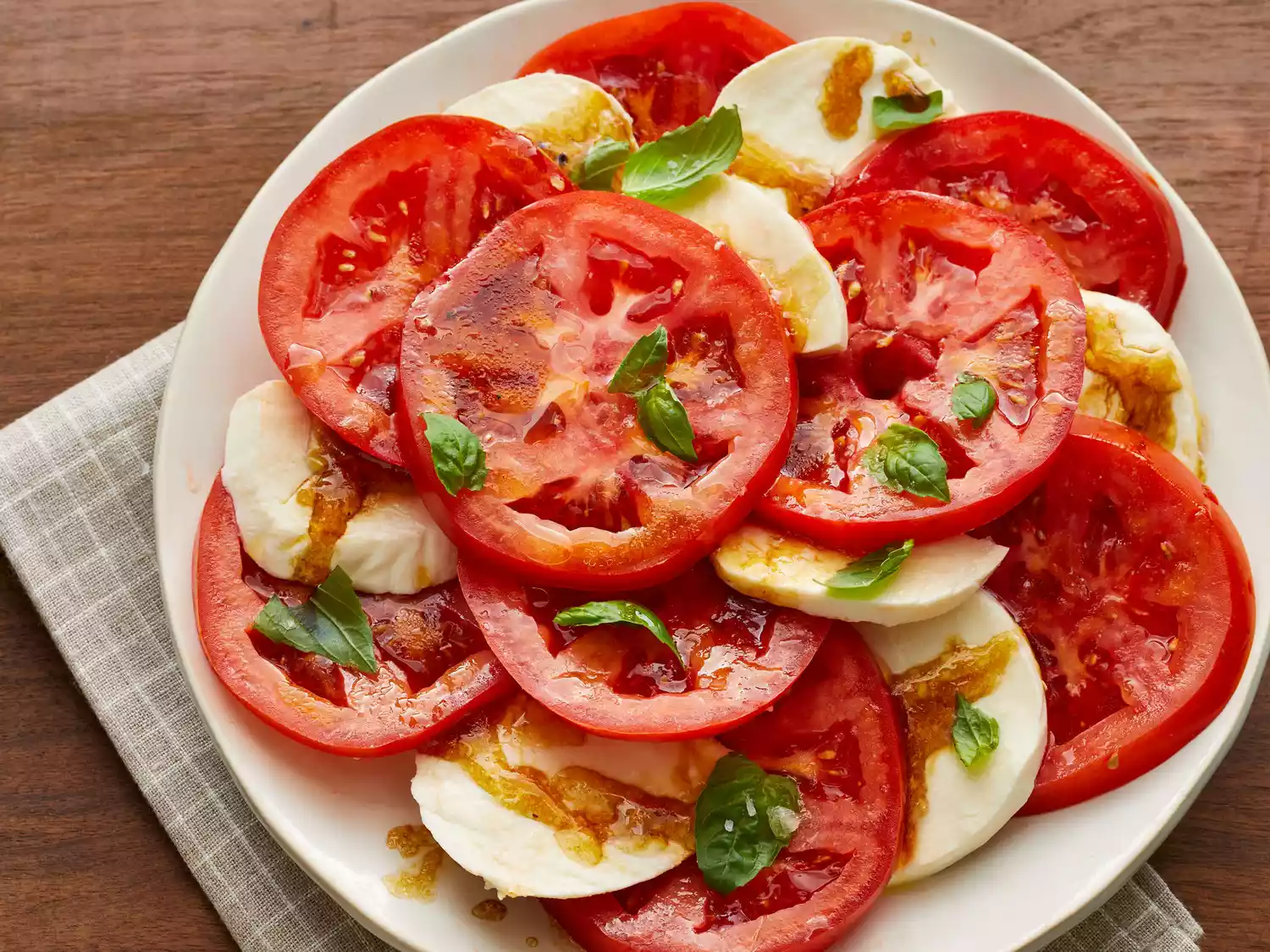 Finished tomato mozzarella salad topped with fresh basil ready to serve
